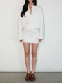 White ribbed knit two-piece set featuring wrap V-neck sweater and matching mini skirt - S / White