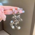 Detail showing long silver twisted metal earrings with white pearls held in hand - 4# Silver Needle-Silver Twisted-Streamlined