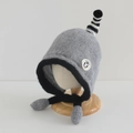 Close-up of knit baby winter hat with penguin patch and soft earflap details - 54cm (3-8 Years) / Gray
