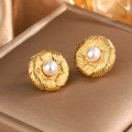 Detail of vintage 18K gold plated earring with braided texture and inset white pearl - Gold + White Pearl