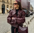 Detailed street style view of an oversized burgundy leather jacket with wide lapels - S / Burgundy