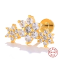 Macro shot of gold S925 sterling silver flower cartilage stud earring with sparkling zircons - Single Gold-Crown Flower Cluster