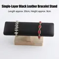 Single-tier black leather watch and bracelet stand with light rubber wood base - Black PU Leather