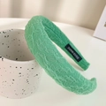 Chic green padded sponge headband with pleated texture and a handmade label detail - Forest Green Pleated Sponge Headband