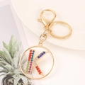 Detail of gold keychain letter K featuring vibrant multicolor rhinestones and lobster clasp - Letter K