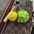 Close-up of mini baseball keychain with wood bat, yellow ball and green glove on bag - 3.5CM Yellow Ball Green
