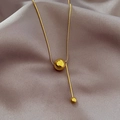 Macro shot of 18K gold plated snake chain with polished round bead and vertical metal bar - Gold