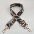 Macro detail of khaki nylon strap with dark green leaf pattern and gold hardware - Dark Green Gold Buckle