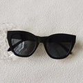 Classic black cat-eye sunglasses with glossy frames and vintage fashion styling - Black