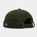 Close-up of olive green docker hat featuring white embroidered logo and cotton twill texture - Adjustable / Army Green