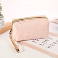 Pink cosmetic bag with gold star patterns, zipper closure and convenient carry handle - Pink