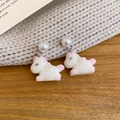 Detailed view of white flocked unicorn drop earrings with shiny round pearls - Silver Pin Flocked Style / White-Pony