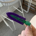 Close-up of a purple and green retro hair clip with a sleek oil paint finish - Purple & Green