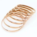 Lot de sept joncs minimalistes en or rose en acier inoxydable poli pour femme - Diamètre intérieur 55mm / Ensemble de 7 Anneaux / Or rose