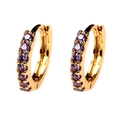 Detailed macro view of 18K gold plated huggie earrings featuring inlaid purple zircons - Purple