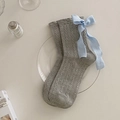 Grey cable knit knee high socks featuring light blue ribbon bows on a glass tray - One Size / Gray