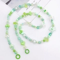 Detail of green beaded crossbody chain with acrylic flowers and sturdy metal rings - Green Mixed Color Beads