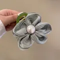 Elegant grey fabric flower hair scrunchie with white pearl center and green clip - Green Floral Hair Claw