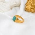 Detail of vintage 18k gold plated ring featuring an oval turquoise gemstone on silk - Amazonite