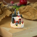Nahaufnahme eines leuchtenden Weihnachtshauses aus Harz mit Weihnachtsmann - Stil C