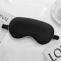 Black silk-like sleep mask with white piping and elastic strap for eye protection - Black with White Edge