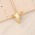 Macro shot of a vintage gold bull head pendant on a textured beige stone pedestal - 3D Stainless Steel Pure Gold Bull Head (11#)