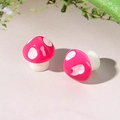 Close-up of pink and white resin mushroom stud earrings with glossy finish and clear details - Rose Red