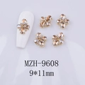 Detail view of champagne crystal 3D flower nail charms on a white manicure display - Champagne Gem - Gold Tone Base (MZH-9608)