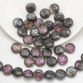 Macro detail of spiral texture glass beads in black and iridescent purple for DIY jewelry - Half Gun Black Purple