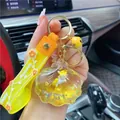 Yellow shell keychain with gold star sequins, silicone wrist strap, and metal bell - Yellow-Shell Unicorn
