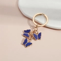Golden keychain featuring three blue acrylic butterflies with sparkling rhinestones decoration - Blue