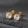 Detail view of 6mm round clear zircon studs with golden stainless steel screw back - 6mm / Gold