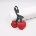 Pastoral style leather cherry bag charm with green leaves and golden snap button closure - Red
