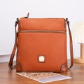 Detailed view of caramel pebble leather crossbody bag with golden square metal hardware - Brown