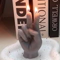 Gray victory gesture finger candle with double wicks on a speckled tray - Gray