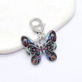Macro detail of acrylic butterfly keychain with colorful patterns and heart clasp - Black Multicolor Butterfly (Heart Clasp)