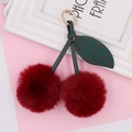 Detail of plush cherry keychain with deep red fur balls and green leather leaves - Spring Ring / Burgundy