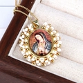 Close-up of Virgin Mary religious pendant with colorful beads in a wooden jewelry box - Guadalupe Virgin Mary / White