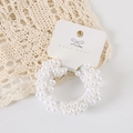 Close-up of white woven faux pearl hair tie on a handmade card with lace details - Card Packaging / Pure White