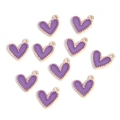 Close-up of ten purple enamel heart charms with golden beaded edges on white background - Heart-shaped Beaded Style / Purple