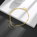 Detailed shot of gold layered snake chain and bead necklace on a white geometric stand - Double Layer Gold Round Bead Snake Chain (C209)