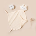 Detail of baby muslin comforter in cream yellow with fox head and soft cotton texture - Off White