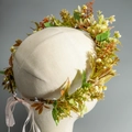 Detailed close-up of floral headband with yellow and orange faux flowers and pink ribbon - Yellow Orange & Green Style (HS-J7171)