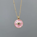 Gold chain necklace with pink shell pendant featuring a zircon Evil Eye design - Pink