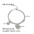Detail of heart charm bracelet with 'Blind for Love' engraving on stainless steel - 18K Gold
