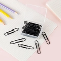 Set of black metal paperclips in a clear storage box on a neat desk organizer setup - Black
