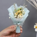 Close-up of mini bouquet with yellow dried roses, white baby's breath, and blue wrap - Yellow Rose (Light Blue Wrapping)