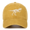 Detailed view of the white T-Rex skeleton embroidery on the mustard yellow cotton baseball cap - One Size / Yellow