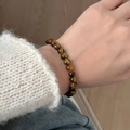 Natural tiger eye stone beaded bracelet with golden brown cat-eye effect on wrist - 6mm Grade A Tiger Eye Bracelet