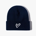 Navy blue winter knitted beanie hat with white embroidered heart detail on white background - One Size / Navy Blue